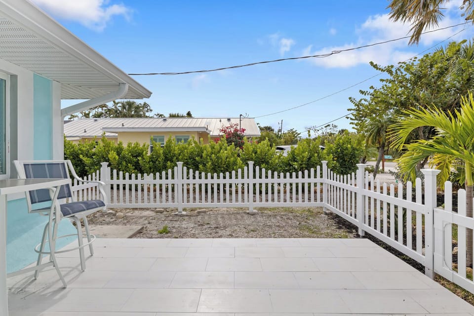Patio off of master bedroom, featuring a high table and two chairs