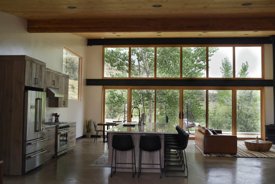 View of kitchen, dining, great room and sliding glass door