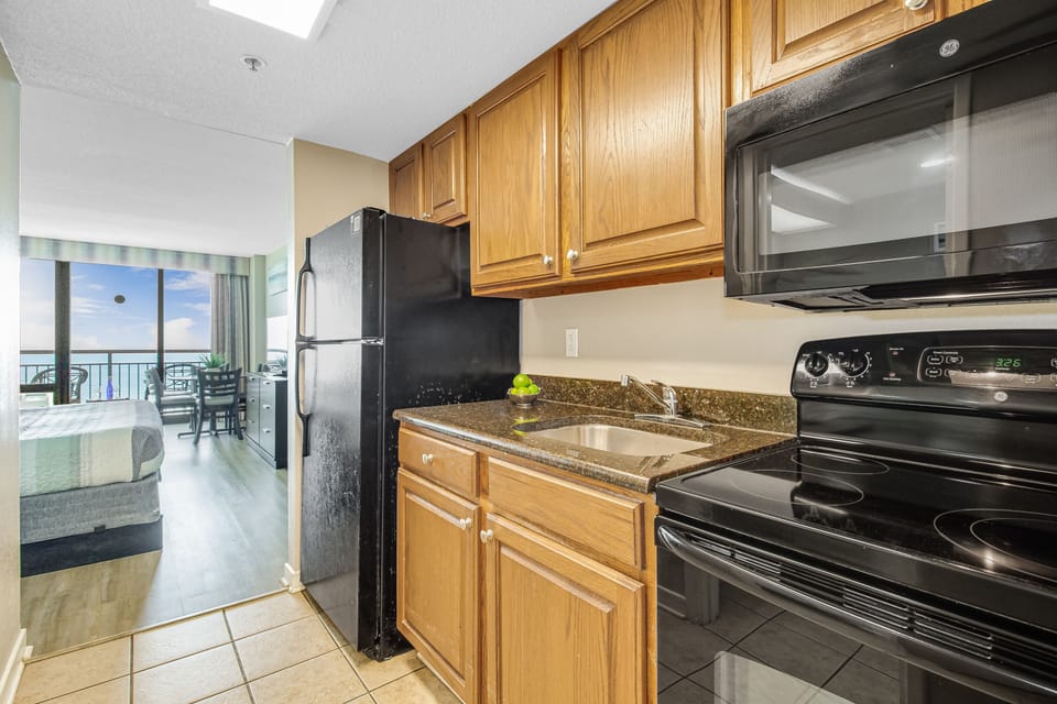 Unleash culinary creativity in the kitchen, equipped with cutting-edge appliances and ample counter space, providing a perfect setting for inspired cooking with a view.