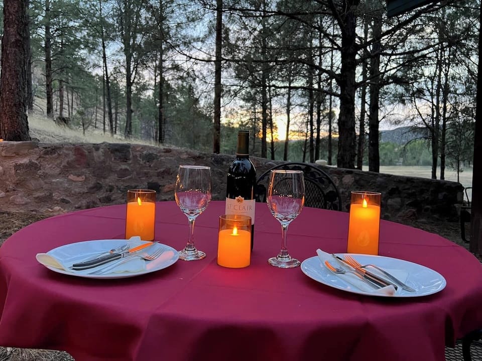 Take advantage of the romantic outdoor setting in the forest...  
The back yard opens directly up to the National Forest.  A round wrought iron table that seats 4 is in the yard, creating a wonderful outdoor dining area. Cabin is equipped with table clothes, remote control candles, wine glasses, wine opener, dishes, utensils... you just bring the food!   

Various feeders are h...
