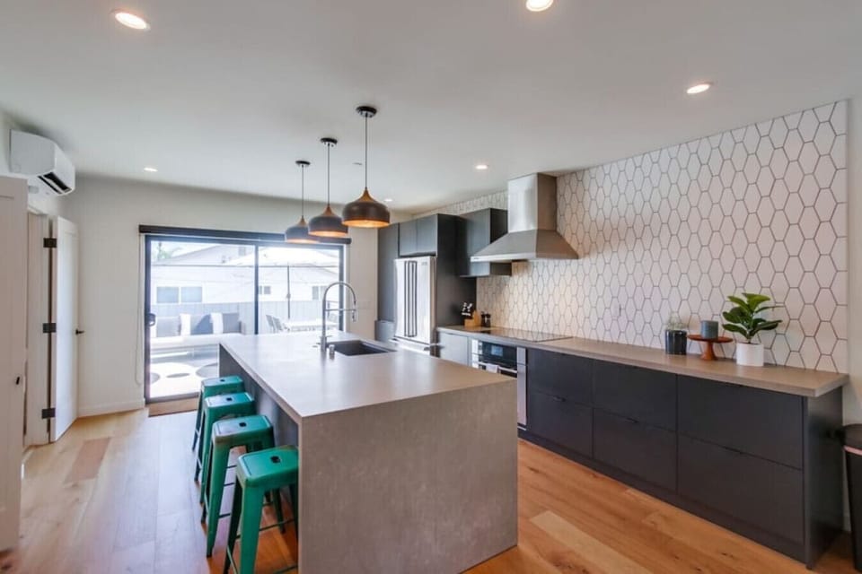 Located on the second floor, this kitchen boasts state-of-the-art appliances, custom cabinetry with soft close technology, waterfall counter top, 4 bar top seats, split system AC, and a southeast facing balcony.