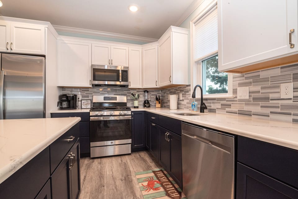 Chic two-tone kitchen with stainless steel appliances
