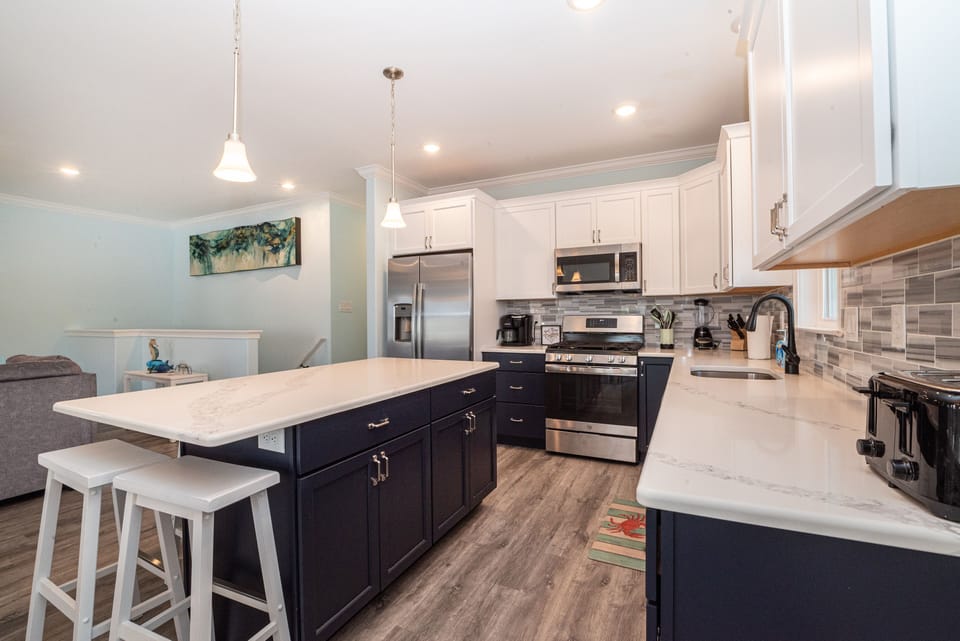 Chic two-tone kitchen with stainless steel appliances