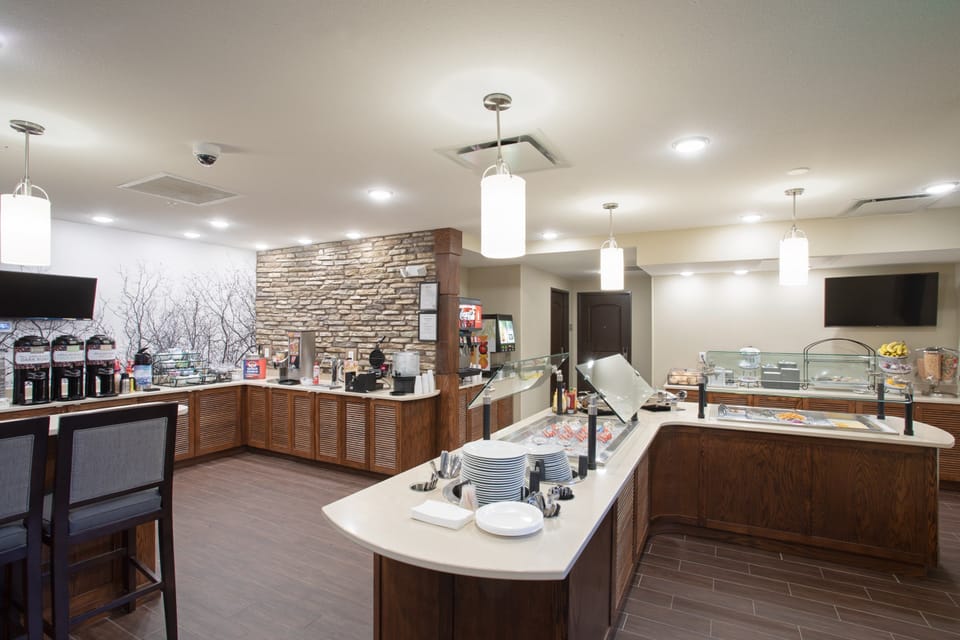 Buffet breakfast area with hot food stations and seating.