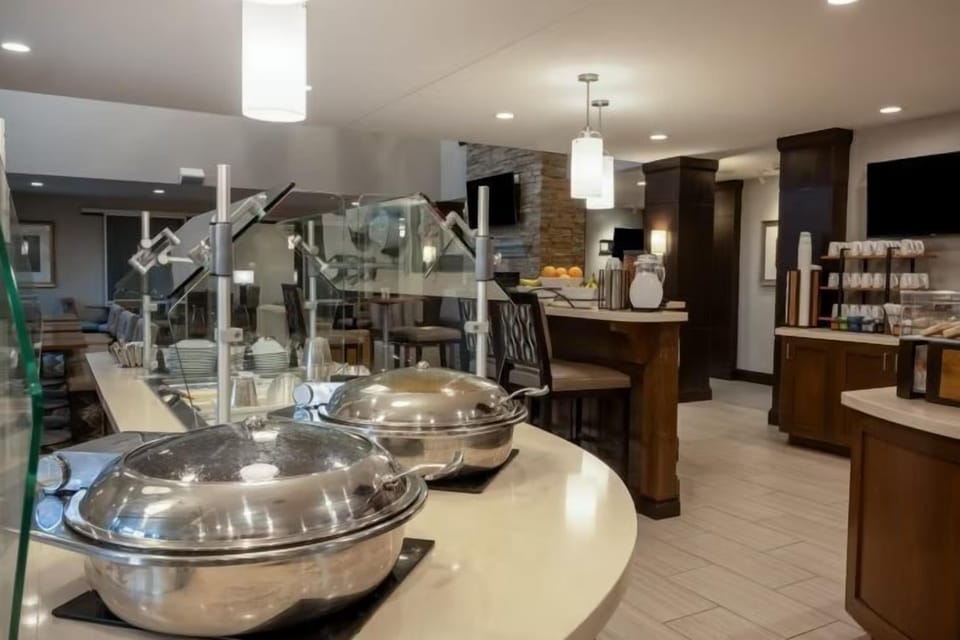 Buffet setup in the dining area, with chafing dishes and a bar.