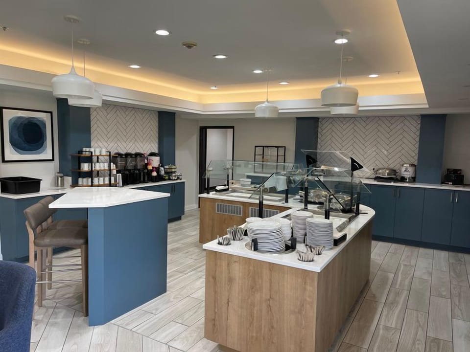 Modern breakfast buffet area with coffee stations.