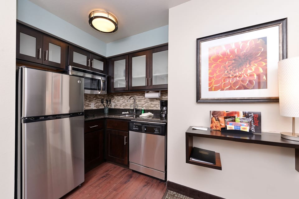 Modern kitchenette with stainless steel appliances and plenty of storage.
