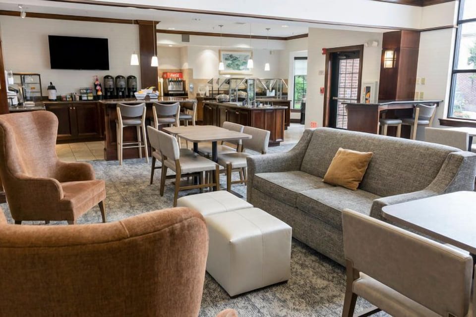 Dining area with rows of tables set for the complimentary hot breakfast served Monday through Friday