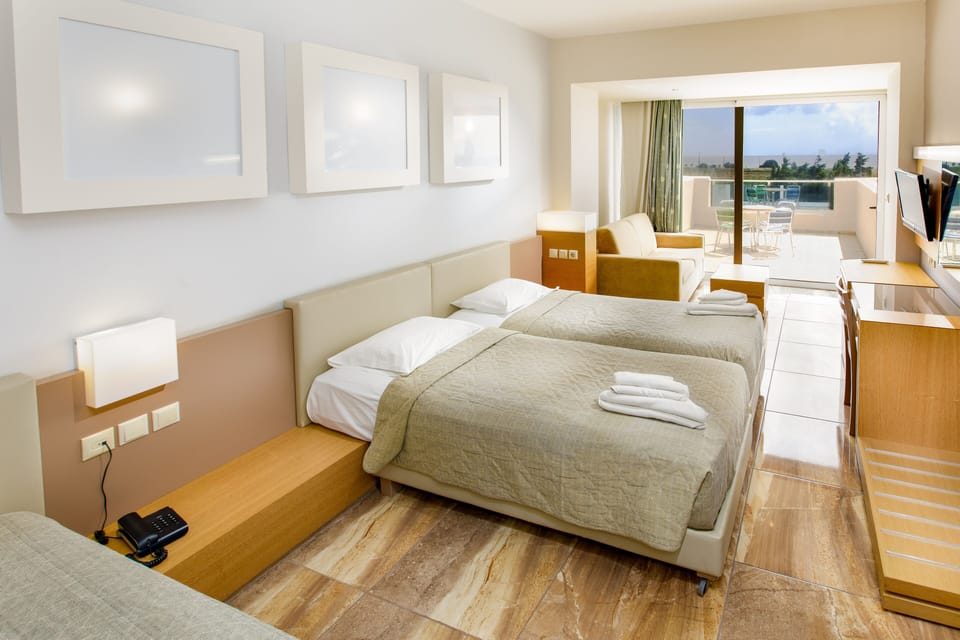 Quadruple Room, Sea View | Living area | Flat-screen TV