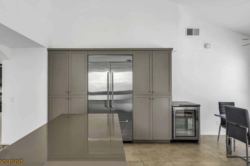 Kitchen with large refrigerator and wine cooler