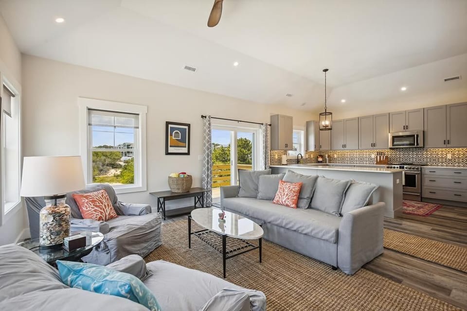 Relax in your bright, open-plan living space where natural light and cozy furnishings invite you to unwind. Your fully equipped kitchen makes home-cooked meals a breeze.