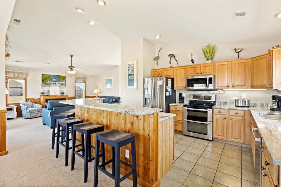 The modern kitchen is fully equipped for preparing everything from quick breakfasts to gourmet dinners.