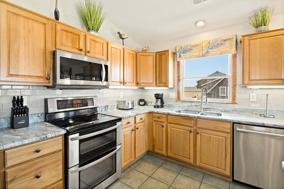 The modern kitchen is fully equipped for preparing everything from quick breakfasts to gourmet dinners.