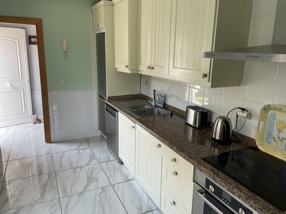Fully fitted kitchen with hob oven and microwave and dishwasher.