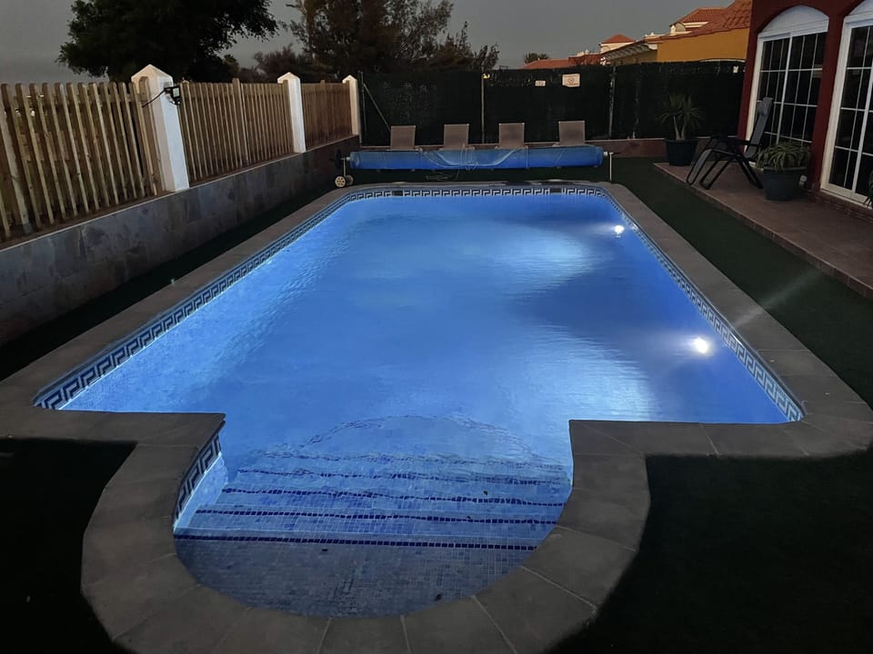 Large heated pool fully illuminated for night time use.