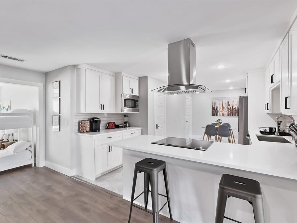 Sparkling white with upgraded counters and backsplashes, this dream kitchen looks like it waltzed off the latest HGTV show!