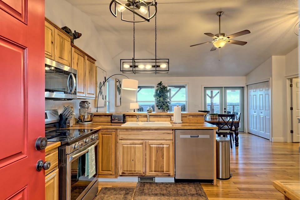Stainless Steel appliances, modern lighting, and a Kitchen Aid Mixer.