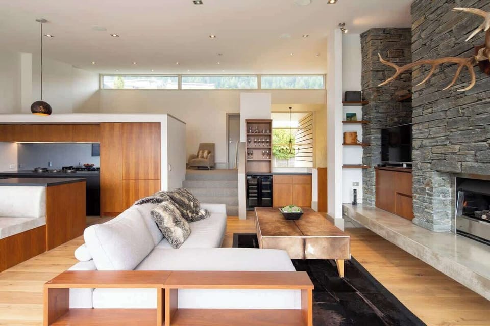 Relax and Unwind: Gather with loved ones in the living room featuring a gas fireplace and luxurious decor, all within walking distance to Queenstown.
Luxury accommodation New Zealand