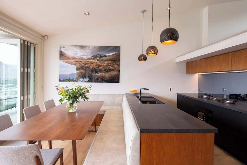 Cook with a View: Modern kitchen boasting sleek appliances and stunning lake and mountain views, perfect for preparing meals in a breathtaking setting.
Queenstown, NZ