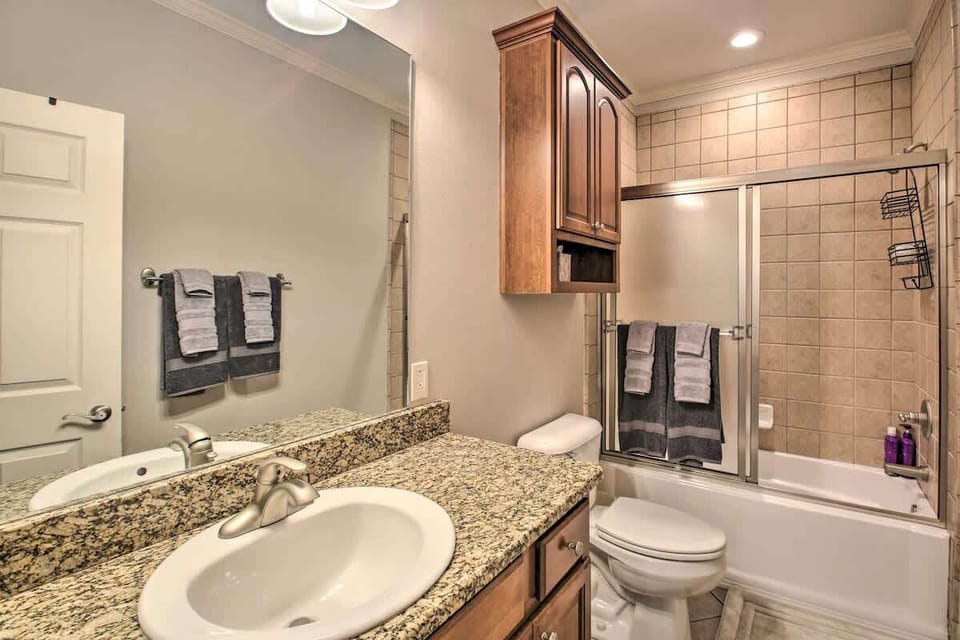 Full bathroom with granite vanity, tiled shower/tub combo, and fresh towels provided