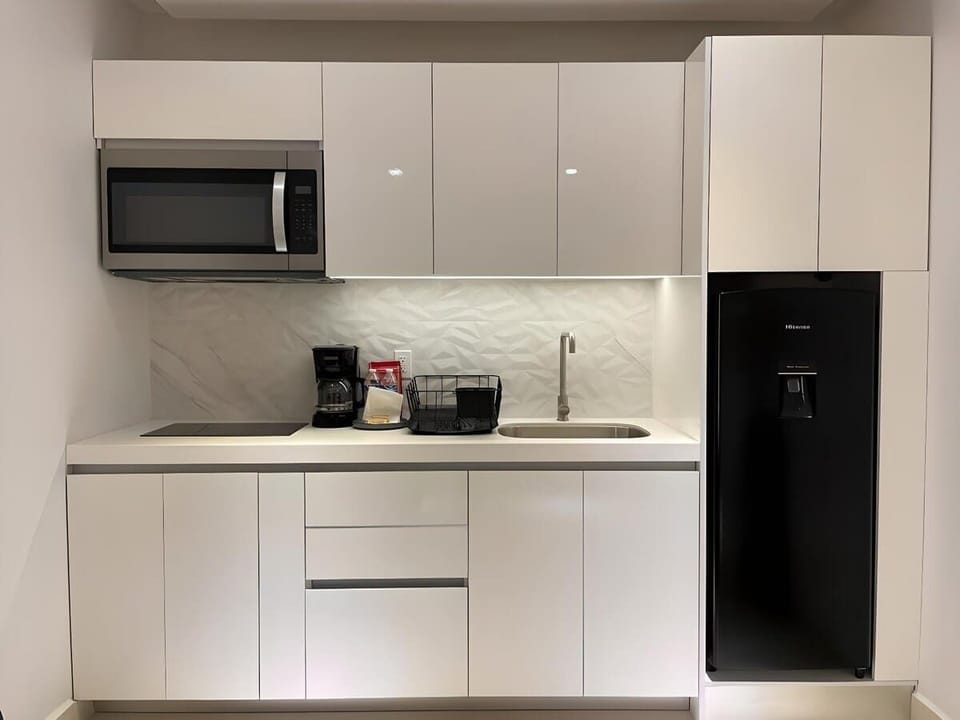 Kitchenette with microwave, fridge and coffee maker