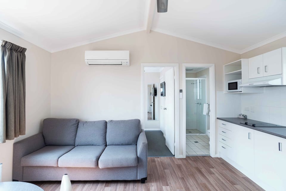 Deluxe Two Bedroom Cabin | Living area | Flat-screen TV