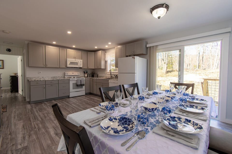 Fully equipped kitchen with formal dining room seating adjacent to living room  