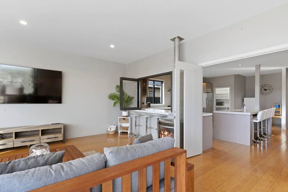 A welcoming lounge seamlessly connects to the kitchen, outside space and down to the private jetty..