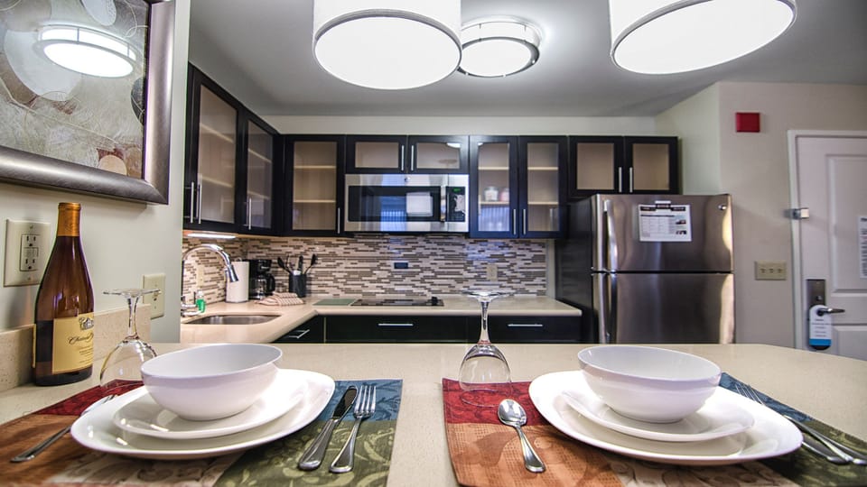 Elegant dining setup with kitchen counter and premium tableware.