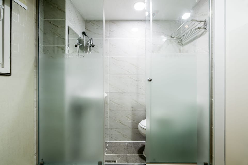 Shower, hair dryer, slippers, towels