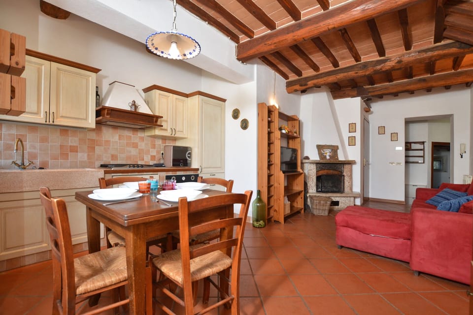 The living room with dinner area and kitchen corner