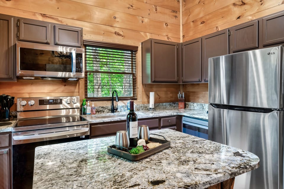 Renovated kitchen with brand-new stainless steel appliances and spacious granite island.