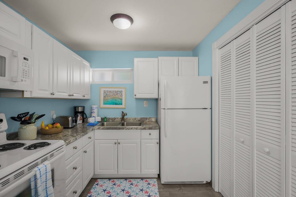 Fully equipped kitchenette with stove, microwave, coffee maker—perfect for light meals and morning coffee.