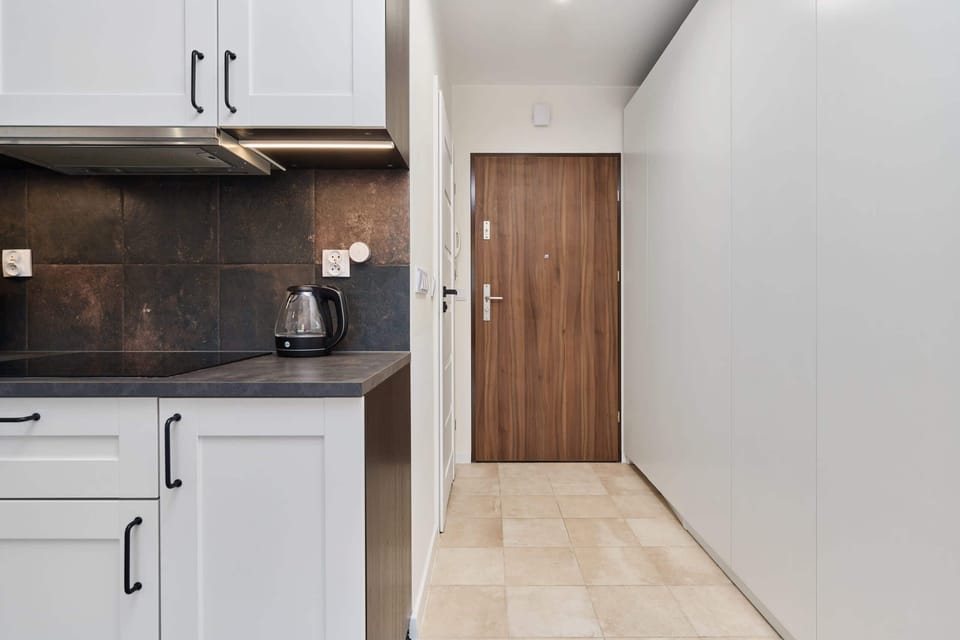 The sleek design of the kitchenette blending seamlessly with the living area.