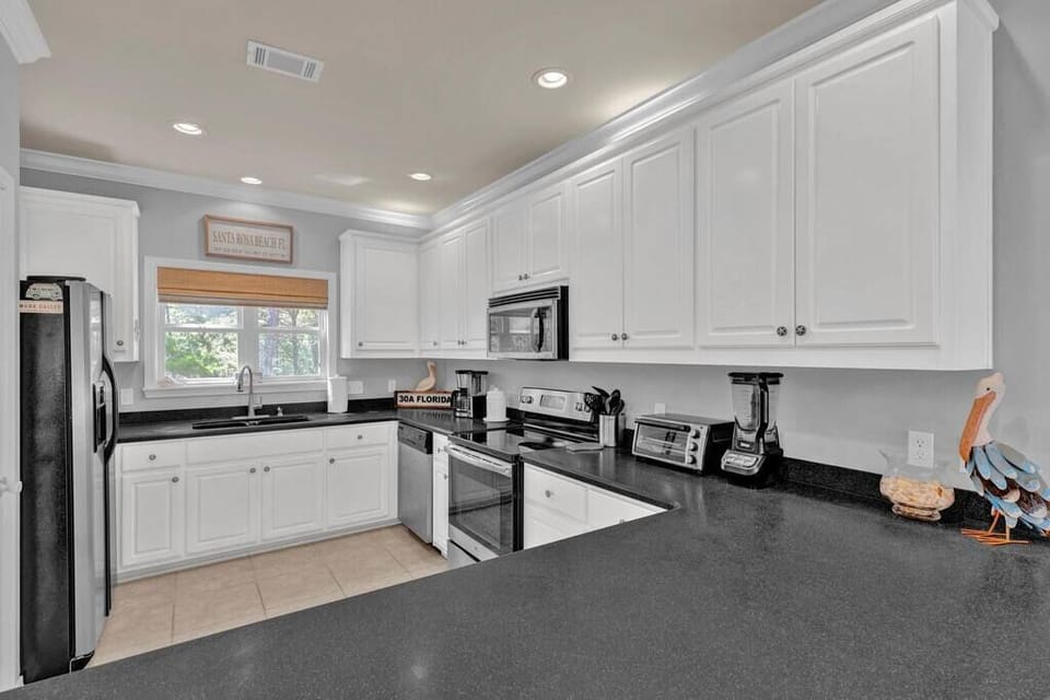 Large kitchen with plenty of counter space, all major appliances, and a pantry. 