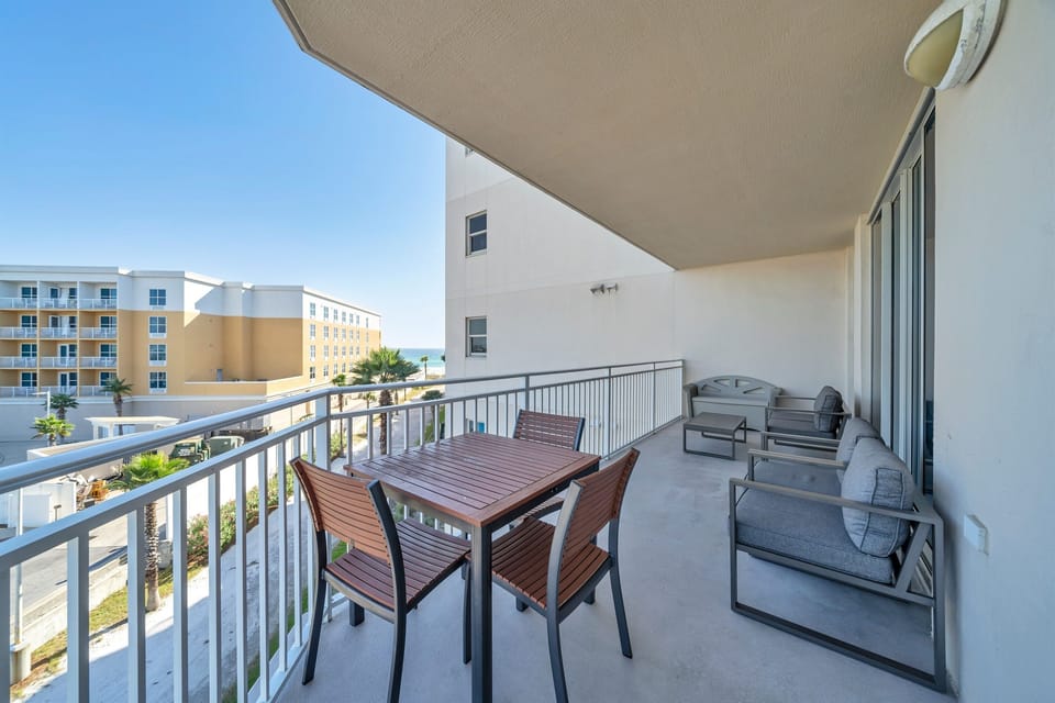 Balcony with partial ocean view with provided beach toys in storage bench