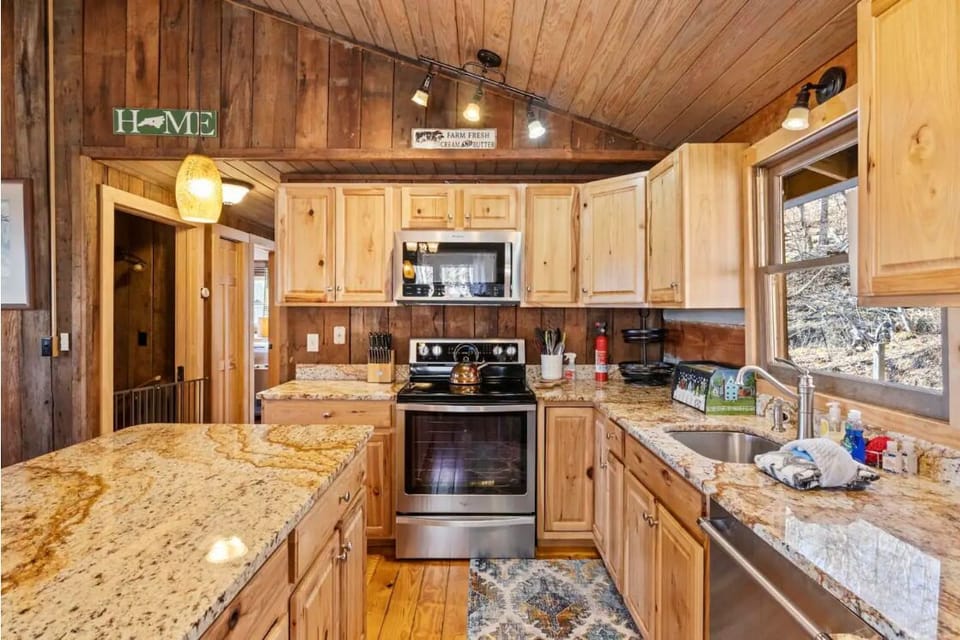 Kitchen well stocked with cookware, dishes, appliances, spices.