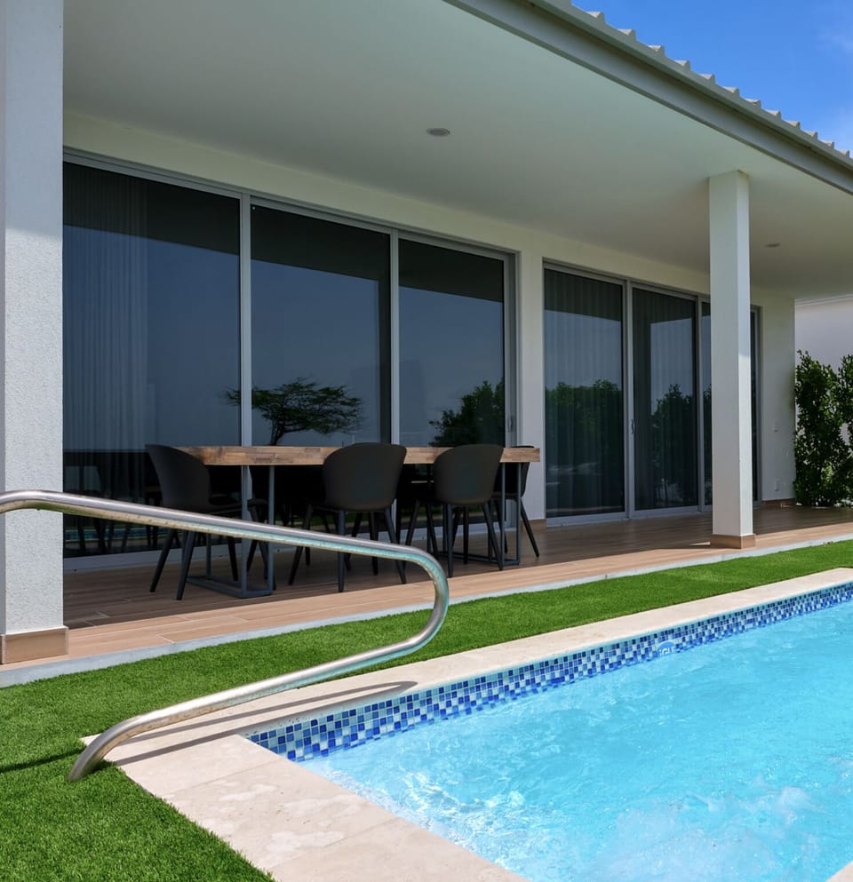 Backyard with a dining area and plunge pool