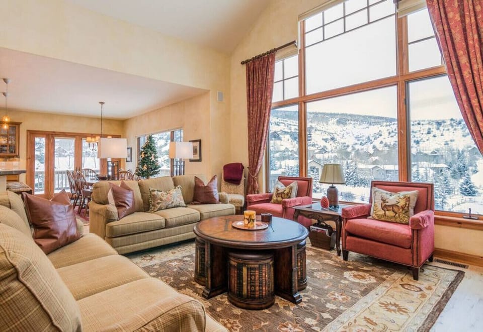 Sunlight pours through floor-to-ceiling windows, creating a warm and open feel