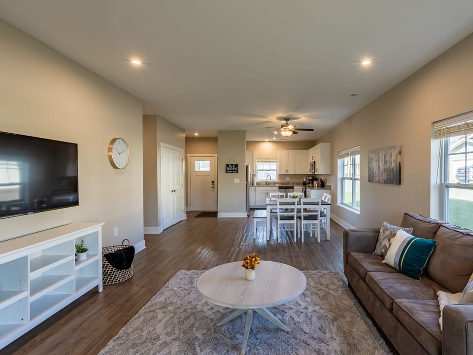 Deluxe Condo | Living area | 55-inch Smart TV with digital channels, TV, streaming services