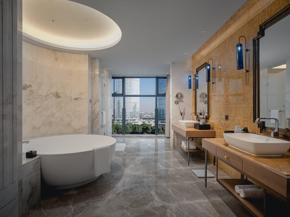Suite, 1 Bedroom, Garden View | Bathroom | Hydromassage showerhead, designer toiletries, hair dryer, bathrobes