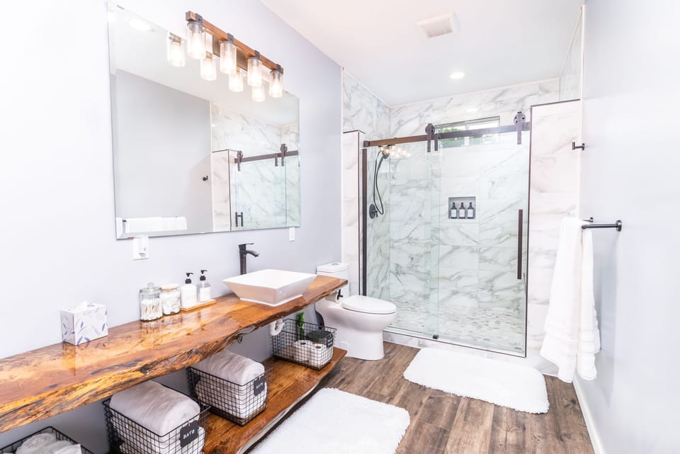 Custom bathroom with large walk-in shower and live edge vanity.