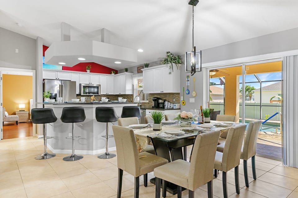The dining room has a view of the pool & sits off the kitchen