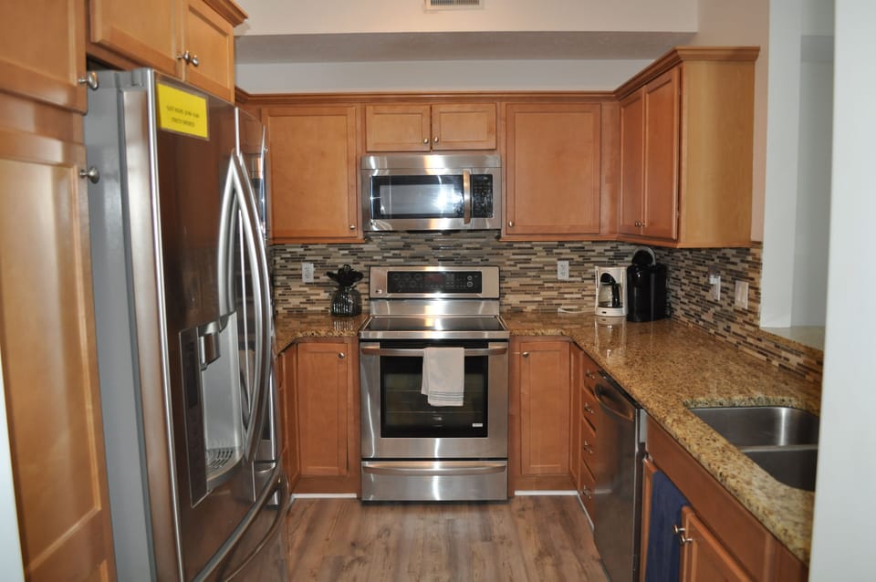 Fully equipped kitchen with stainless steel appliances.
