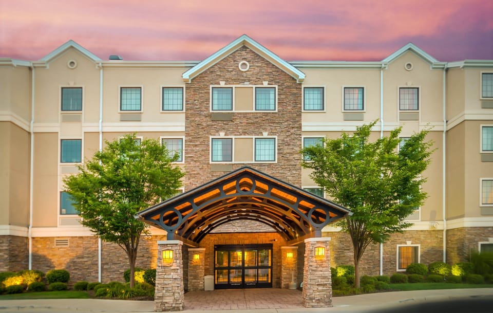 Hotel exterior at dusk — the building is steps from The Shops at Fallen Timbers