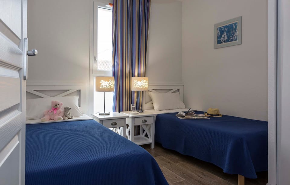 There are 2 Single beds in the second bedroom.