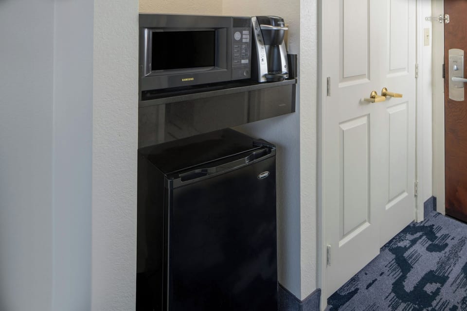 Premium bedding, desk, laptop workspace, blackout drapes