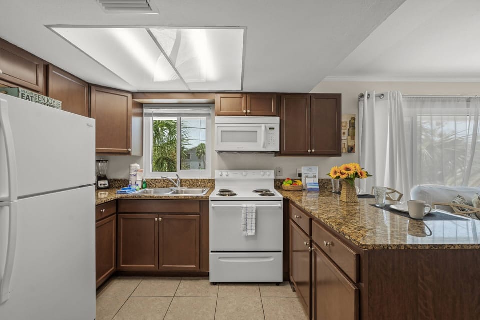 Compact but complete—this efficient kitchenette has everything you need for light cooking, snacks, and beach-day fuel.