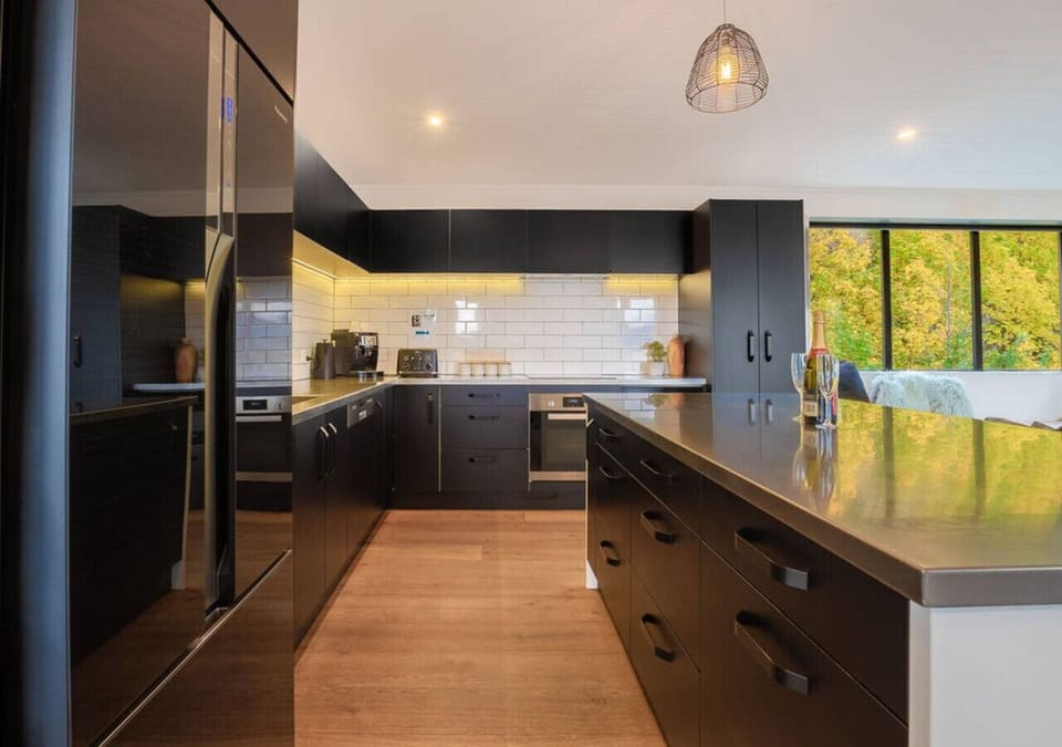 Full size fridge, induction cook top, dishwasher and all you need for meal prep.
