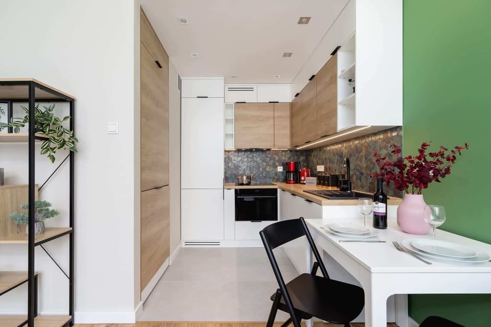 Another view of the kitchenette and dining area, highlighting the efficient use of space and bright ambiance.
